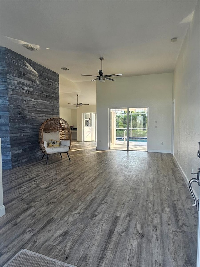 unfurnished living room featuring ceiling fan and wood-type flooring