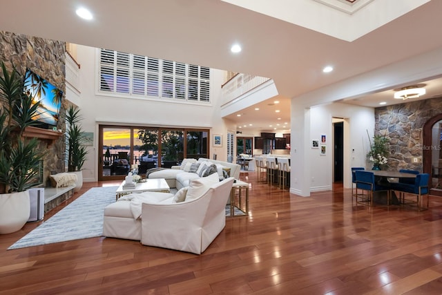 living room featuring hardwood / wood-style floors and a towering ceiling