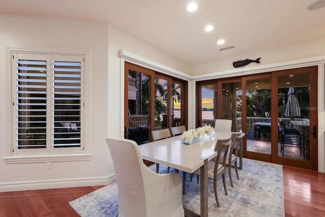 dining space featuring hardwood / wood-style flooring and french doors