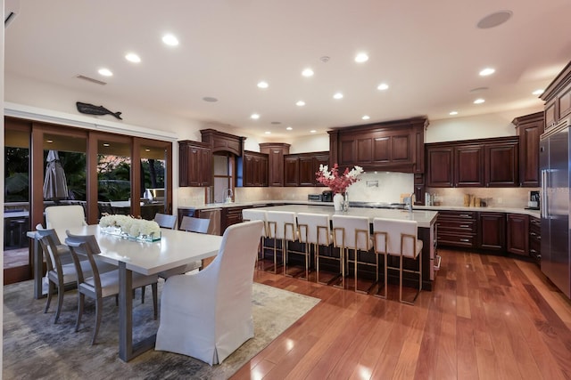 dining area featuring sink and dark hardwood / wood-style flooring