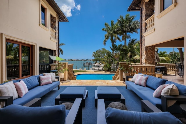 view of pool with a water view and an outdoor hangout area