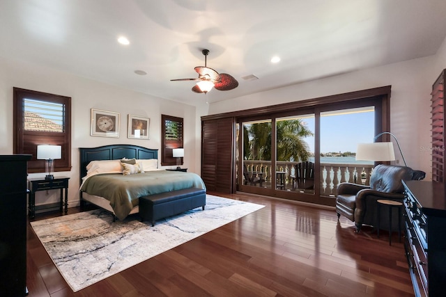 bedroom with access to outside, ceiling fan, dark hardwood / wood-style floors, and multiple windows