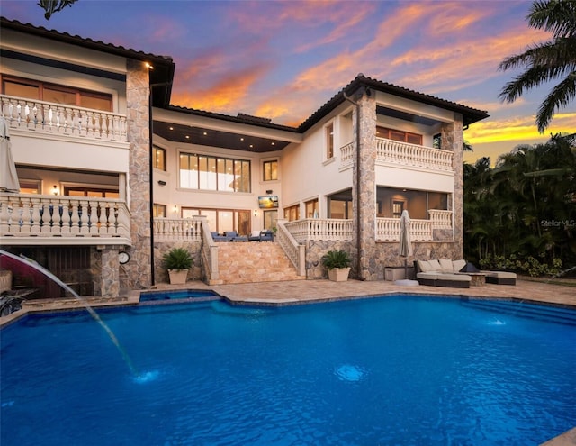 view of pool at dusk