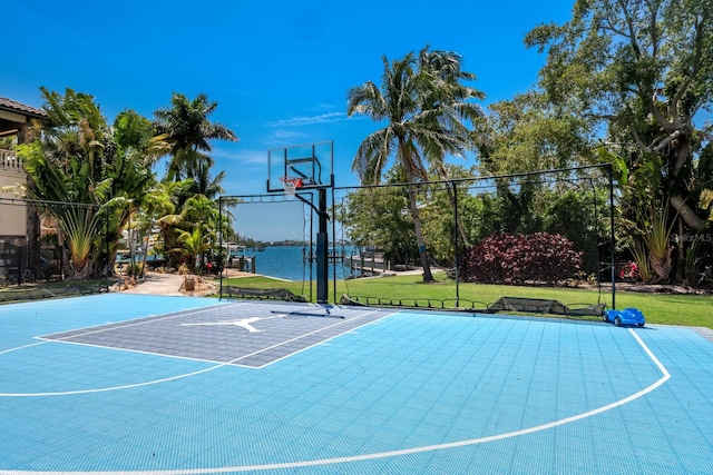 view of sport court with a lawn