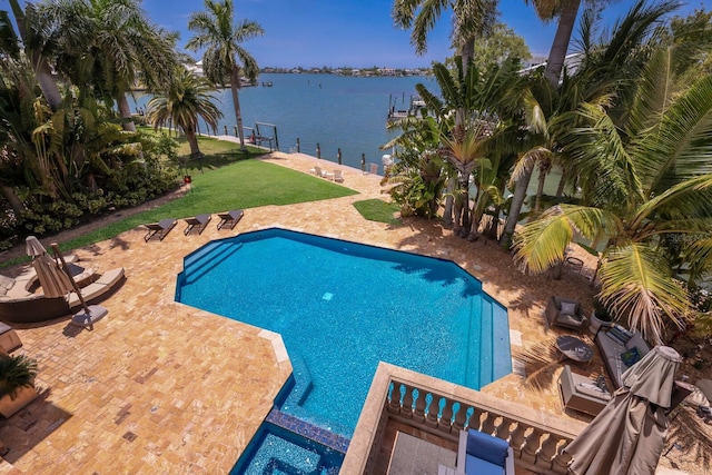 view of swimming pool with a patio and a water view