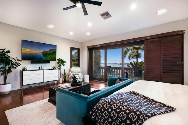 bedroom with dark hardwood / wood-style flooring, ceiling fan, and access to exterior