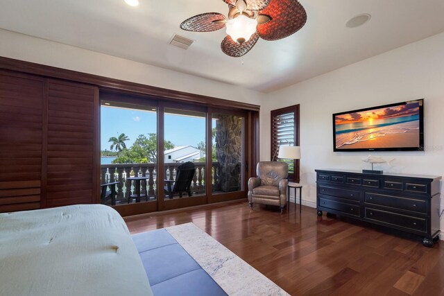 bedroom featuring dark hardwood / wood-style flooring, ceiling fan, and access to exterior