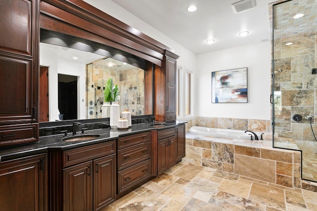 bathroom featuring vanity and separate shower and tub