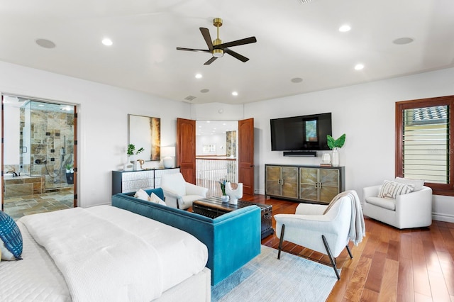 bedroom with ceiling fan, wood-type flooring, and connected bathroom