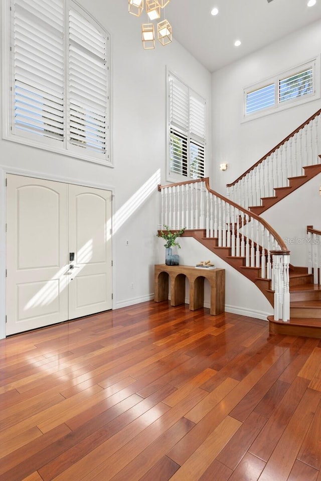 entrance foyer featuring hardwood / wood-style flooring and an inviting chandelier