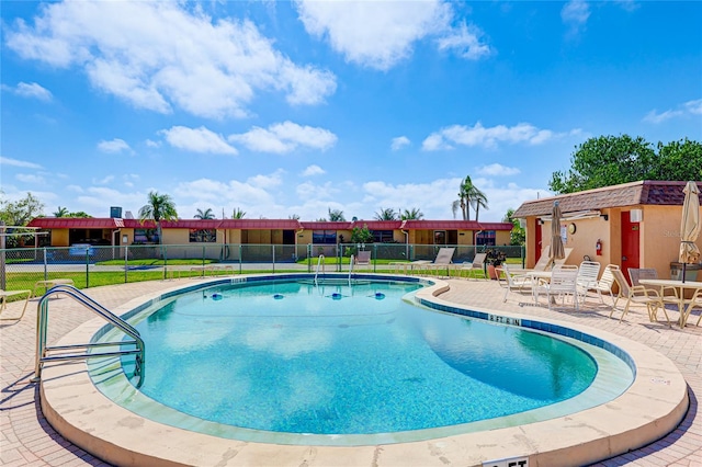 view of swimming pool with a patio