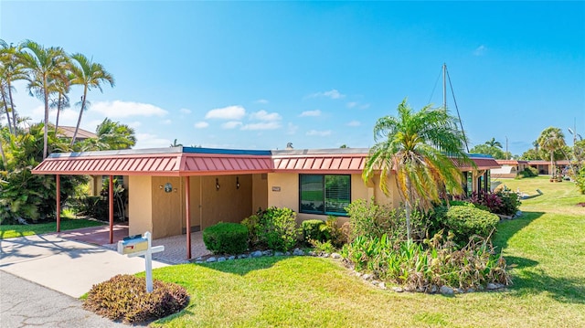 view of front facade with a front yard and a carport