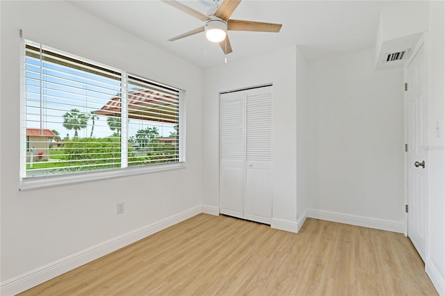 unfurnished bedroom with multiple windows and light hardwood / wood-style flooring