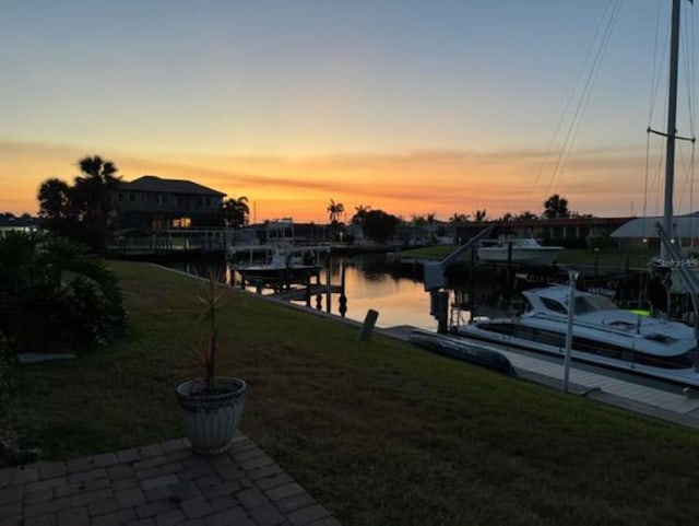 exterior space with a water view and a lawn