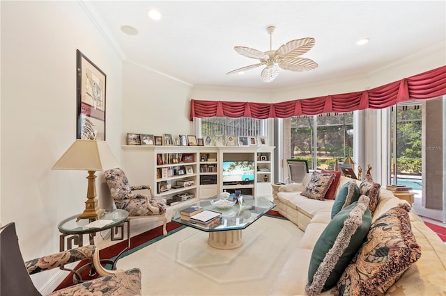 living room with ornamental molding, tile floors, and ceiling fan