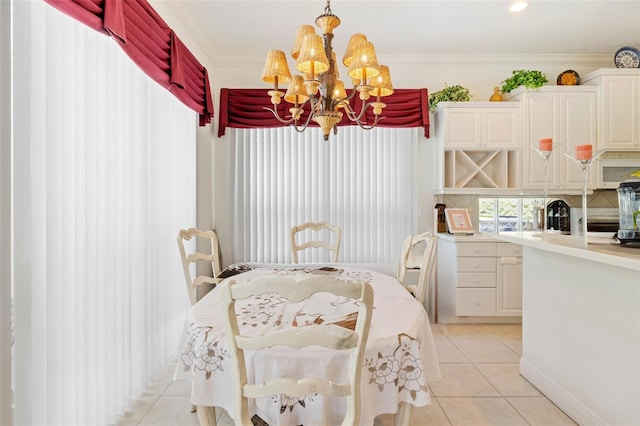 tiled dining space featuring a notable chandelier and crown molding