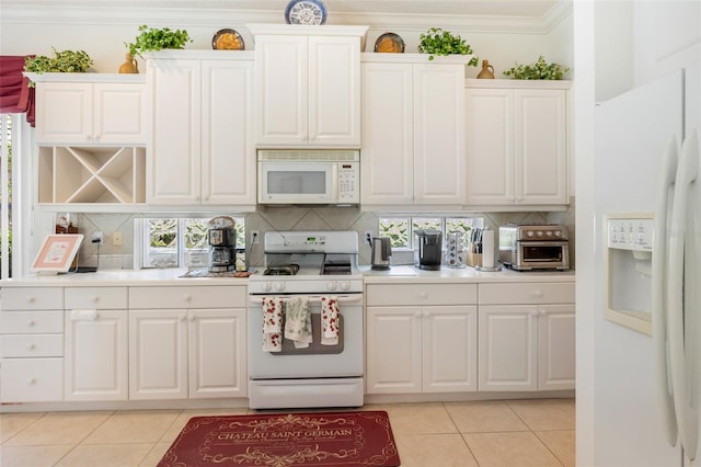 kitchen with ornamental molding, white appliances, tasteful backsplash, and light tile floors