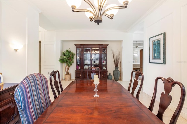 dining space with tile flooring, a notable chandelier, and ornamental molding