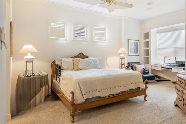 carpeted bedroom featuring ornamental molding and ceiling fan