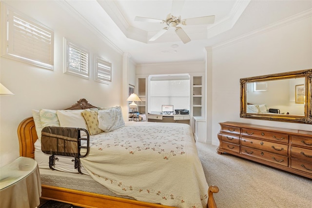 bedroom with ceiling fan, carpet, a raised ceiling, and crown molding