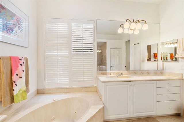 bathroom featuring tile flooring, vanity, and tiled bath