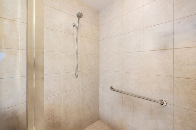 bathroom with a tile shower