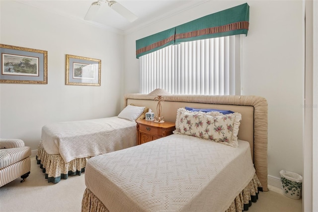 bedroom with carpet floors, ceiling fan, and crown molding