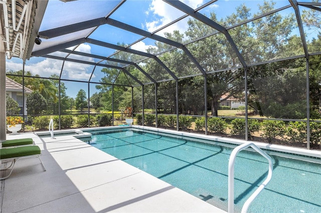 view of swimming pool with a patio and glass enclosure