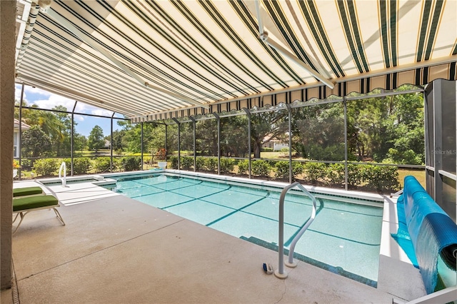 view of swimming pool with a patio area and a lanai