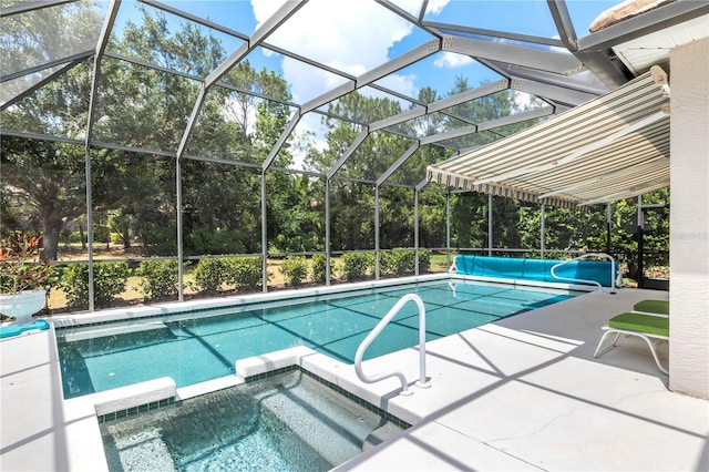 view of pool featuring a patio, a lanai, and an in ground hot tub