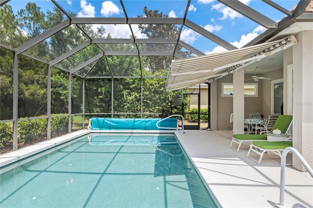 view of pool with a lanai, ceiling fan, and a patio area