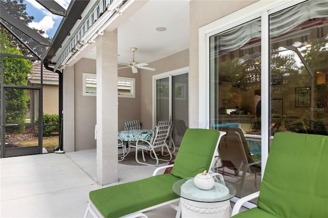 view of patio / terrace with a lanai and ceiling fan