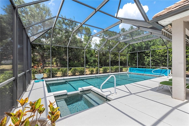 view of pool featuring a patio area, an in ground hot tub, and a lanai