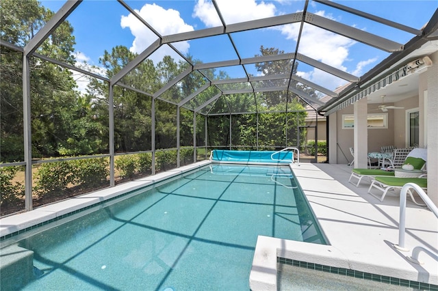 view of pool with a lanai, ceiling fan, and a patio area