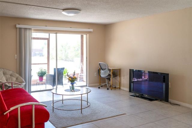 living area with a textured ceiling and tile patterned floors