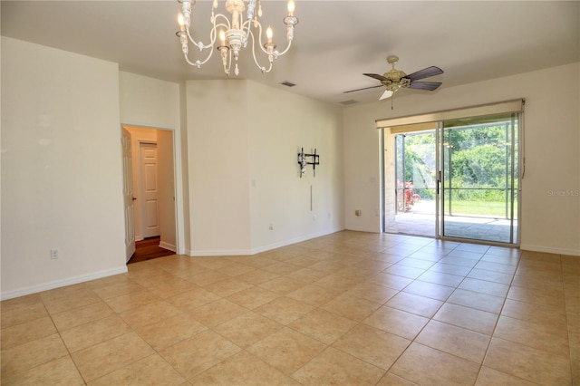 tiled empty room featuring ceiling fan with notable chandelier