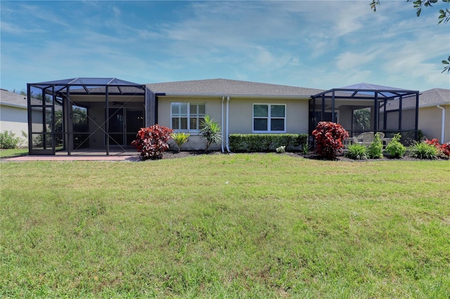 back of property featuring a lawn, a lanai, and a patio