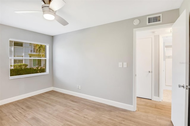 spare room featuring light hardwood / wood-style floors and ceiling fan