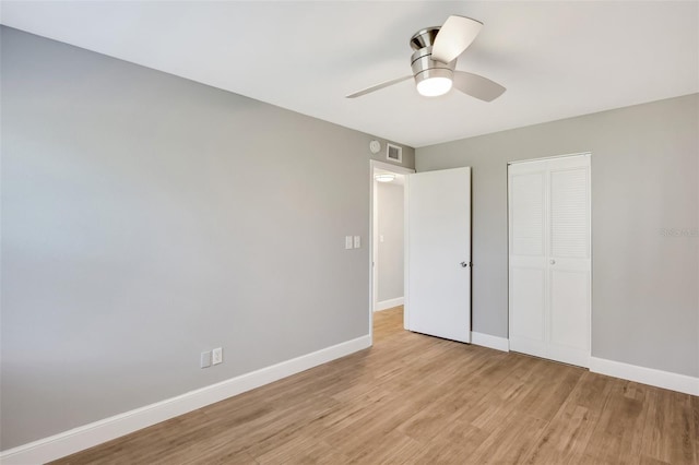 unfurnished bedroom with a closet, light hardwood / wood-style flooring, and ceiling fan