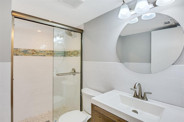 bathroom with walk in shower, backsplash, toilet, vanity, and tile walls