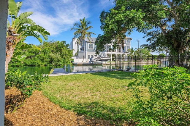 view of yard with a boat dock and a water view