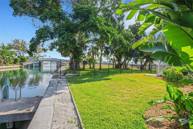 view of yard featuring a water view and a boat dock