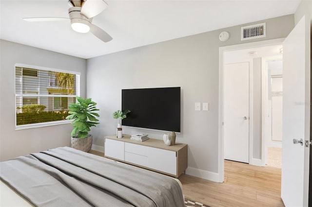 bedroom with light hardwood / wood-style floors and ceiling fan