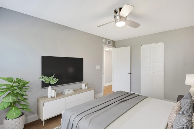 bedroom featuring ceiling fan, a closet, and hardwood / wood-style floors