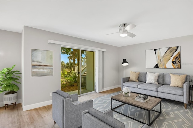 living room with ceiling fan and hardwood / wood-style flooring