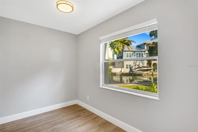 unfurnished room with hardwood / wood-style flooring