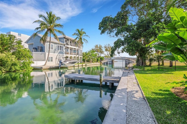 dock area featuring a yard and a water view