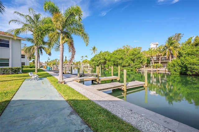 dock area featuring a water view and a lawn