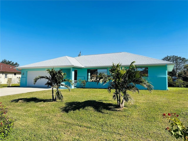 ranch-style home with a garage, concrete driveway, a front yard, and stucco siding