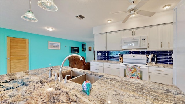 kitchen featuring pendant lighting, white appliances, white cabinets, sink, and decorative backsplash